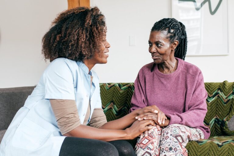 nurse speaking with elderly woman